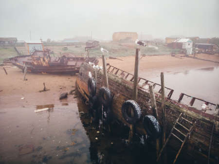 Cemetery of old ships in Teriberka Murmansk Russia, dramatic photo. Aerial top viewの写真素材