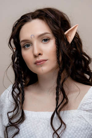 Beautiful fashion brunette woman elf with extended fake eyelashes, concept creative photography beauty industryの写真素材