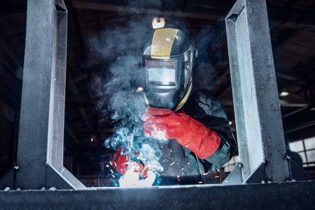 Manual Industrial worker factory welding, banner Professional welder erecting metal steelの写真素材