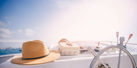 Concept banner sea travel. Modern boat steering wheel on luxury yacht with hat sunlightの写真素材