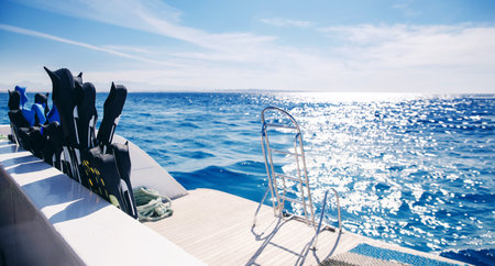 Banner photo tour on boat snorkeling or diving underwater in sea. Closeup of flippers and blue waterの写真素材