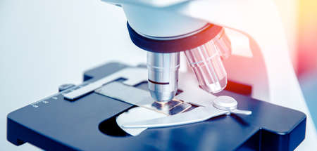 Banner panorama microscope with metal lens at laboratory, red and blue light. Concept industry labの写真素材