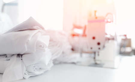 Closeup sewing machine with thread, background white color sun light. Concept Interior of garment factoryの写真素材