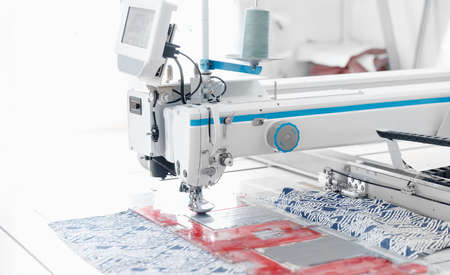 Automatic sewing machine for pocket, background white color. Concept Interior of garment factoryの写真素材