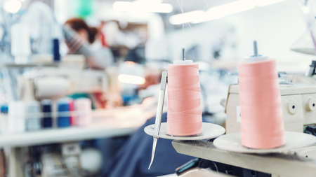 Close-up spool of multicolored threads for sewing machine. Concept Interior of garment factoryの写真素材