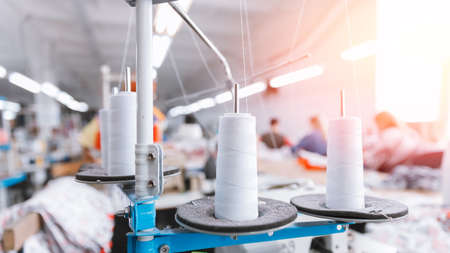 Close-up spool of multicolored threads for sewing machine. Concept Interior of garment factoryの写真素材