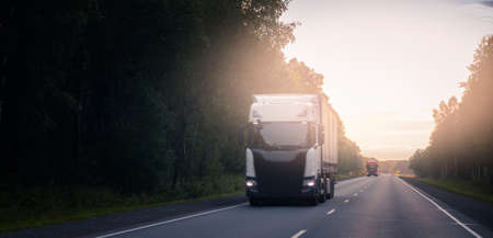 Truck with container on highway with sun light. Concept cargo transportation banner. Blur move effectの写真素材