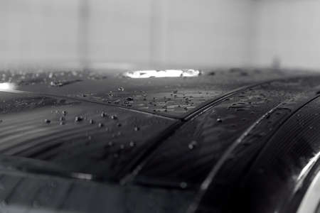 Drops of water on hood of black car after washingの写真素材