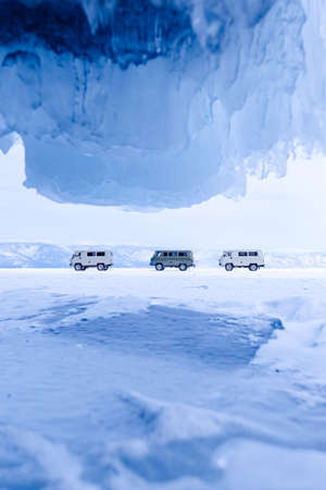 Blue ice cave grotto lake Baikal Russia and car for tourist travel. Frozen icicles, beautiful winter landscapeの写真素材