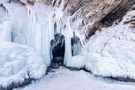 Blue ice cave grotto lake Baikal Olkhon island, Russia. Frozen clear icicles, beautiful winter landscapeの写真素材