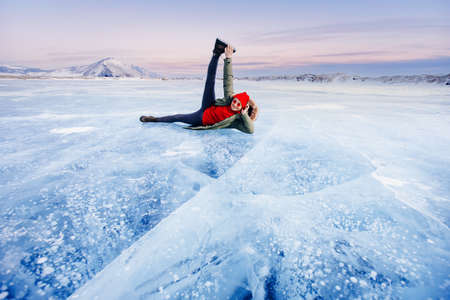 Tourist woman background ice with gas methane bubbles lake Baikal. Adventure winter travel top viewの写真素材