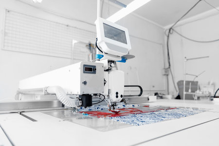 Automatic sewing machine for pocket, background white color. Concept Interior of garment factory