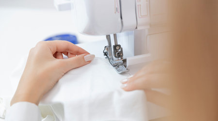 Detail sews clothes on sewing machine in factory, Banner white background