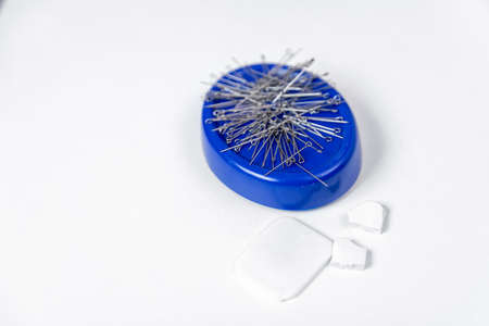 Steel needles for sewing and soap for drawing patterns on fabric on white backgroundの写真素材