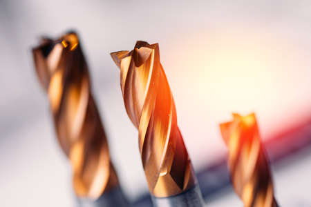 Closeup drill bit set for CNC machine cutting sheet metal with sunlightの写真素材