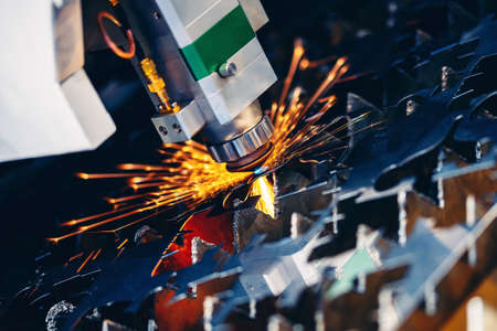 Closeup Laser CNC cut of metal with light spark Blue color. Concept technology industrialの写真素材