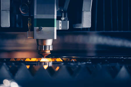 Concept technology industrial Blue color with copy space. Closeup Laser CNC cut of metal with light sparkの写真素材