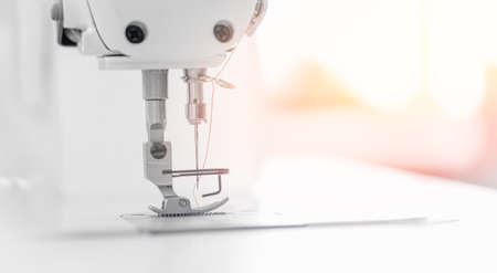 Closeup sewing machine for pocket, background white color sunlight. Concept Interior of garment factoryの写真素材