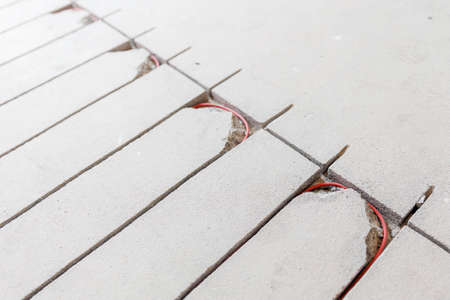 Strobe line in cement screed for laying red electric cable for underfloor heatingの写真素材