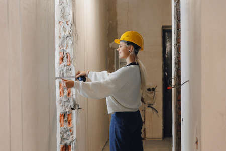 Women foreman architect check work of construction worker with drawing print apartmentの写真素材