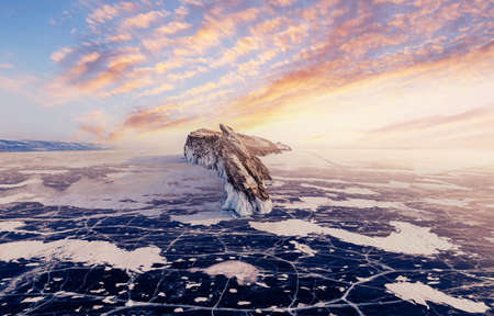 Beautiful landscape island Ogoy winter lake Baikal with transparent cracked blue ice, sunset aerial top view. Concept travel Russiaの写真素材