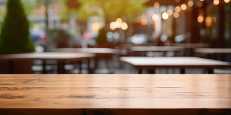 Empty wooden tabletop with a blurred cafe backgroundの素材