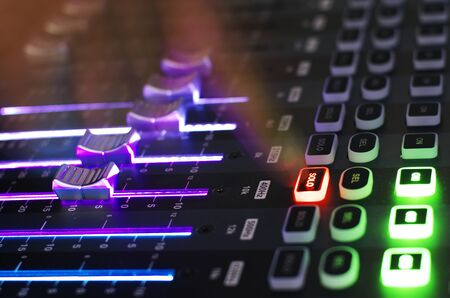 Close Up of Sound Mixer with Working Hand Point to Solo Buttonの写真素材