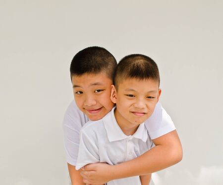 happy asian brother on white backgroundの写真素材