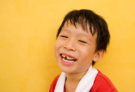 young boy laughs and shows his missing teethの写真素材