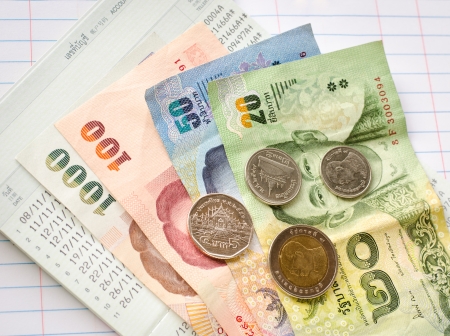 Thai banknotes on bookbank and account book backgroundの写真素材