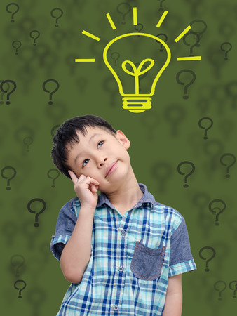 Asian schoolboy thinking with abstract green background and bulbの写真素材