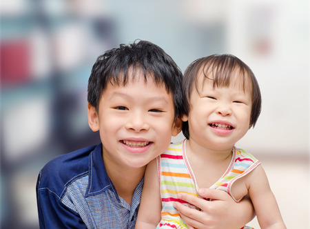 Asian brother and sister smilingの写真素材