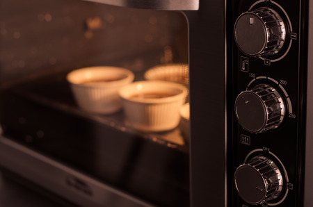 Oven cooking cupcake inside, vintage filterの写真素材