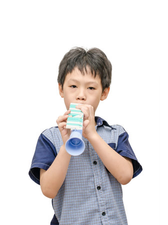 Young Asian boy playing trumpet toy over white background