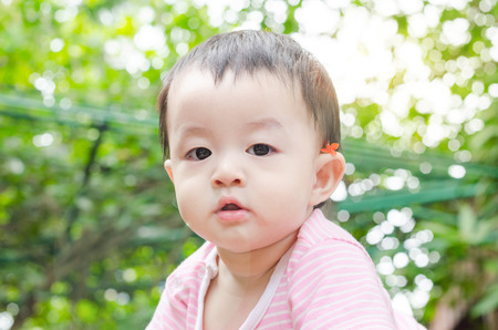 Little Asian child looking at cameraの写真素材