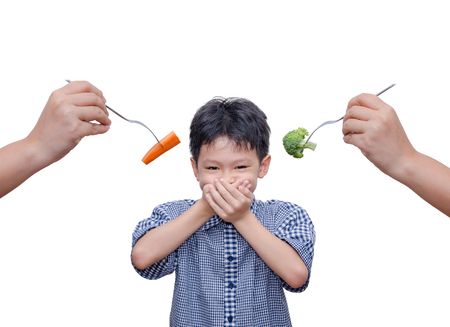 Asian boy close his mouth by hands because don't want to eat vegetablesの写真素材