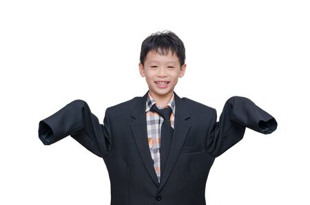 Little Asian boy in big suit over whiteの写真素材