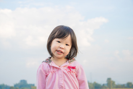 Little asian girl smiling outdoorの写真素材