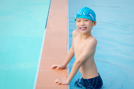 Young asian boy happy at swimming poolの写真素材