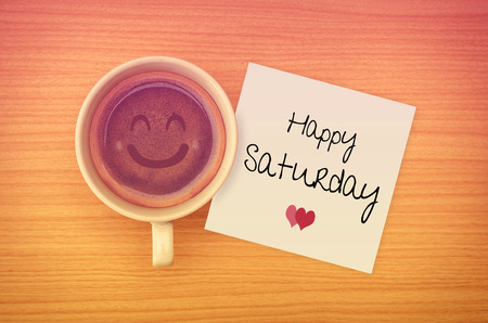 Happy Saturday on paper note with coffee cup,top view.の写真素材