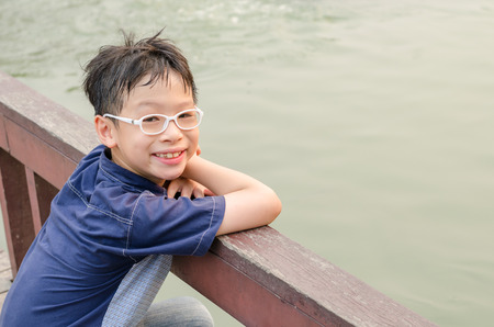 Young Asian boy smiling outdoorの写真素材