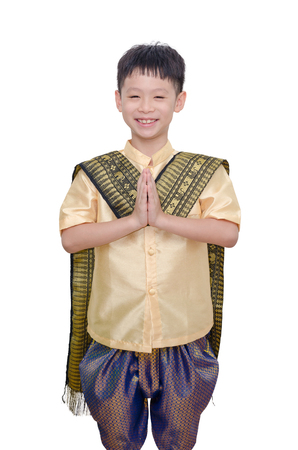 Young boy in Thai traditional dress smiling and do gesture welcomeの写真素材