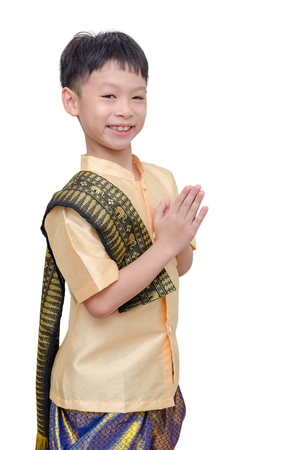 Young boy in Thai traditional dress smiling and do gesture welcomeの写真素材