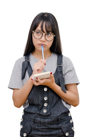 Young asian girl reading book over whiteの写真素材