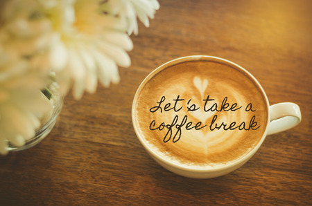 Let's take a coffee break : Quote with coffee cup on wood backgroundの写真素材