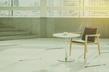 Armchair and table with coffee cup with vintage filterの写真素材