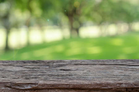wood table top with blurred nature backgroundの写真素材