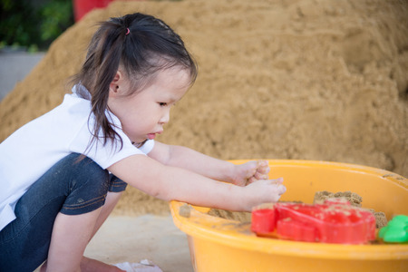 Little asian girl playing in sandboxの写真素材