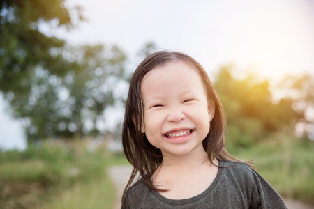 Little asian girl smiling in parkの写真素材