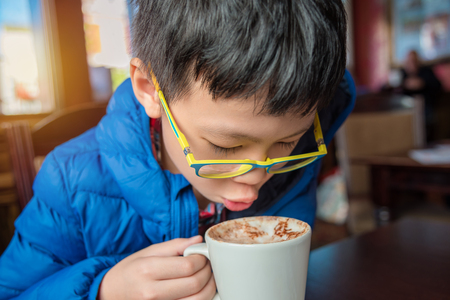 boy drinking hot chocolateの写真素材